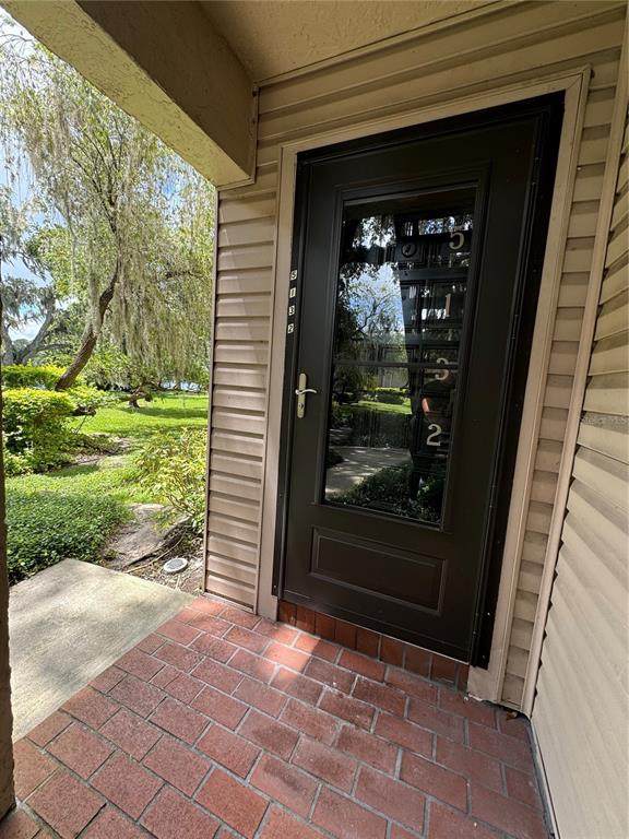 a view of a door and chair in the house front of house