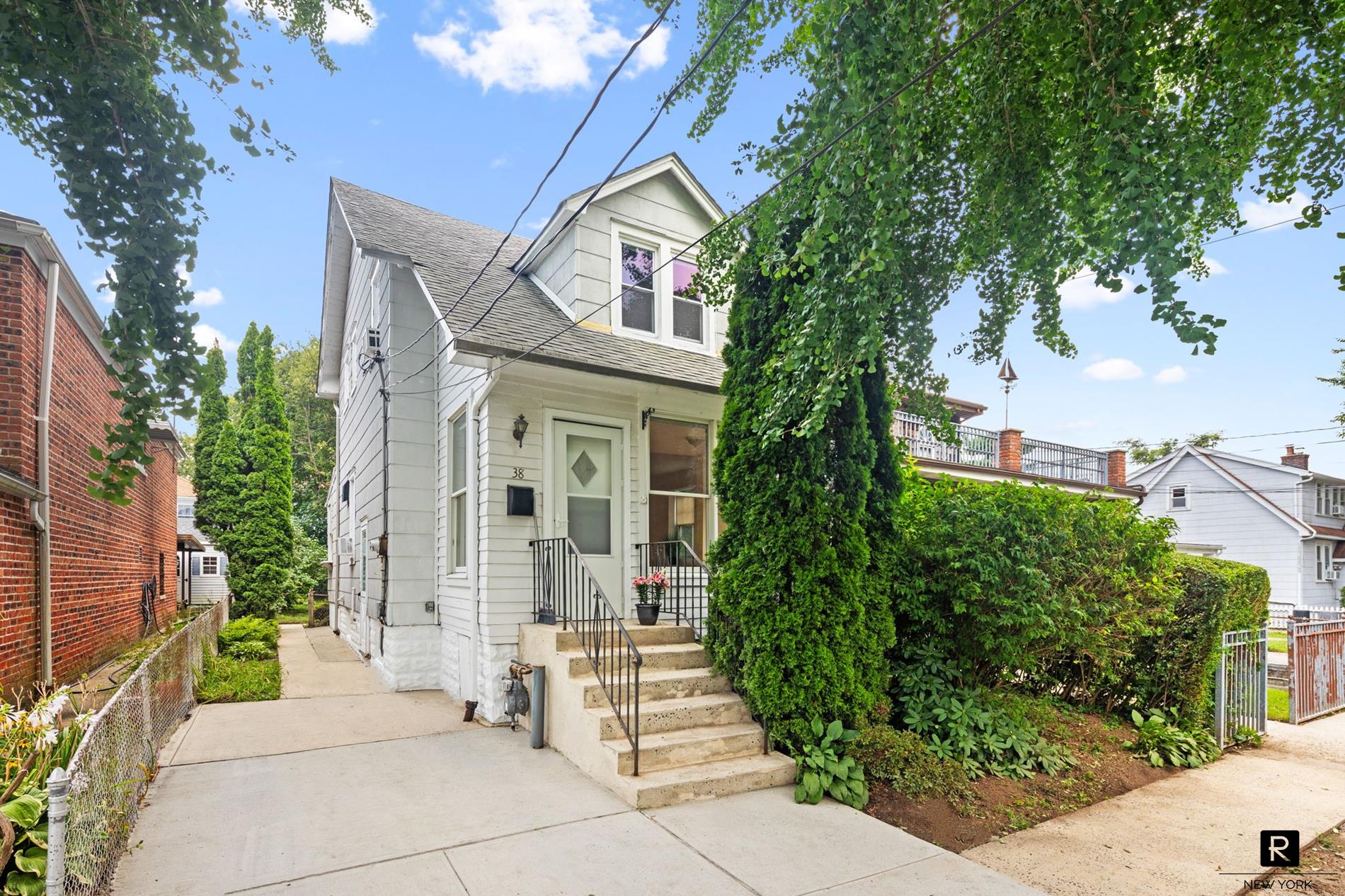 a front view of a house with a garden