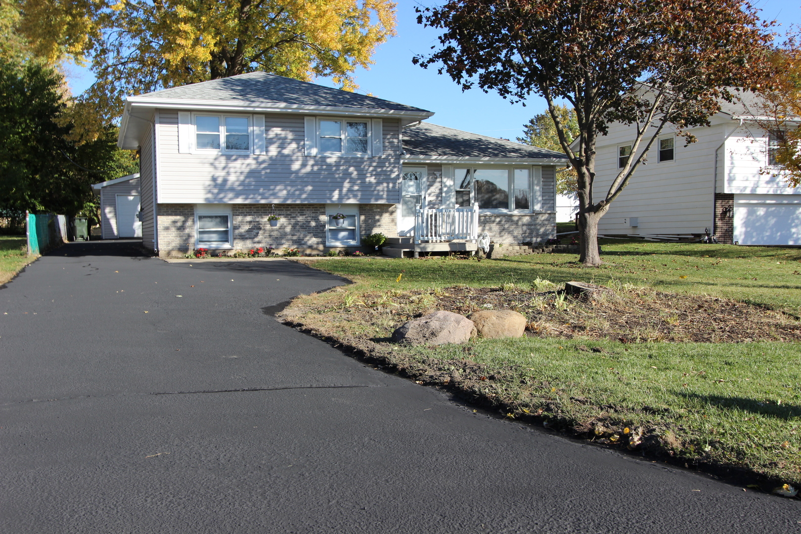 a front view of a house with a garden and pathway