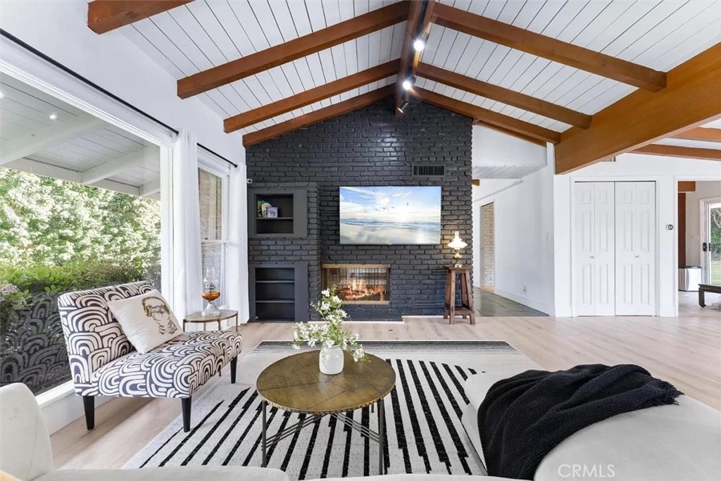 a view of a livingroom with furniture and a window