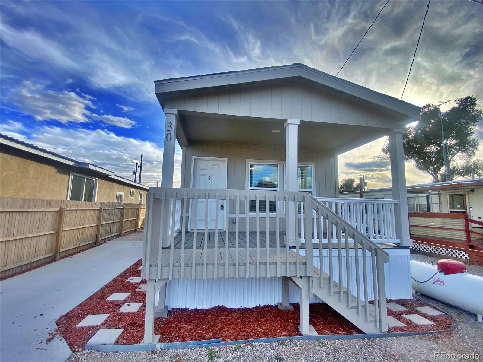 a view of a house with a wooden deck