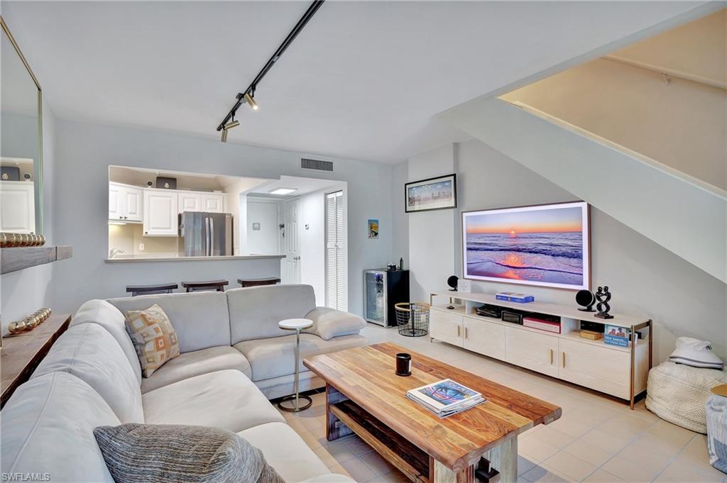 Tiled living room with rail lighting