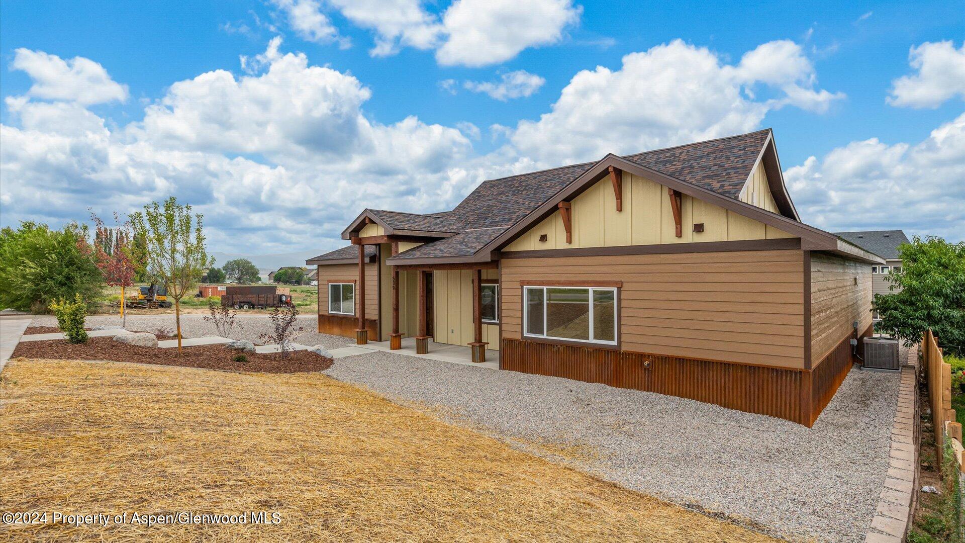 a front view of house with yard outdoor seating and barbeque oven