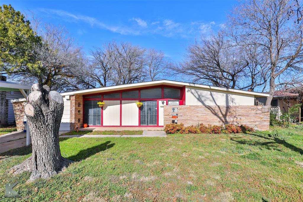 a front view of house with yard and green space