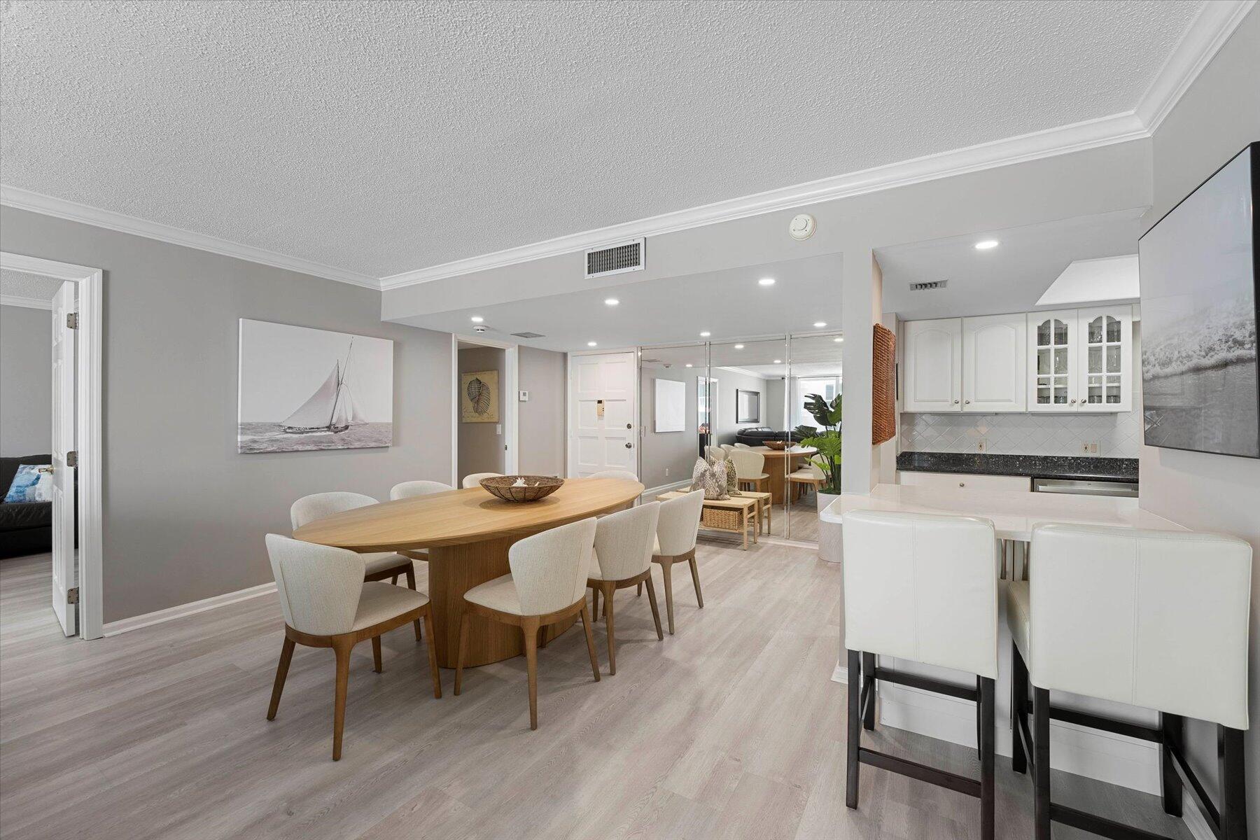 a dining room with furniture and wooden floor