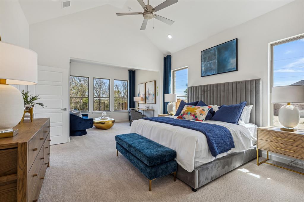 a spacious bedroom with a bed and a chandelier