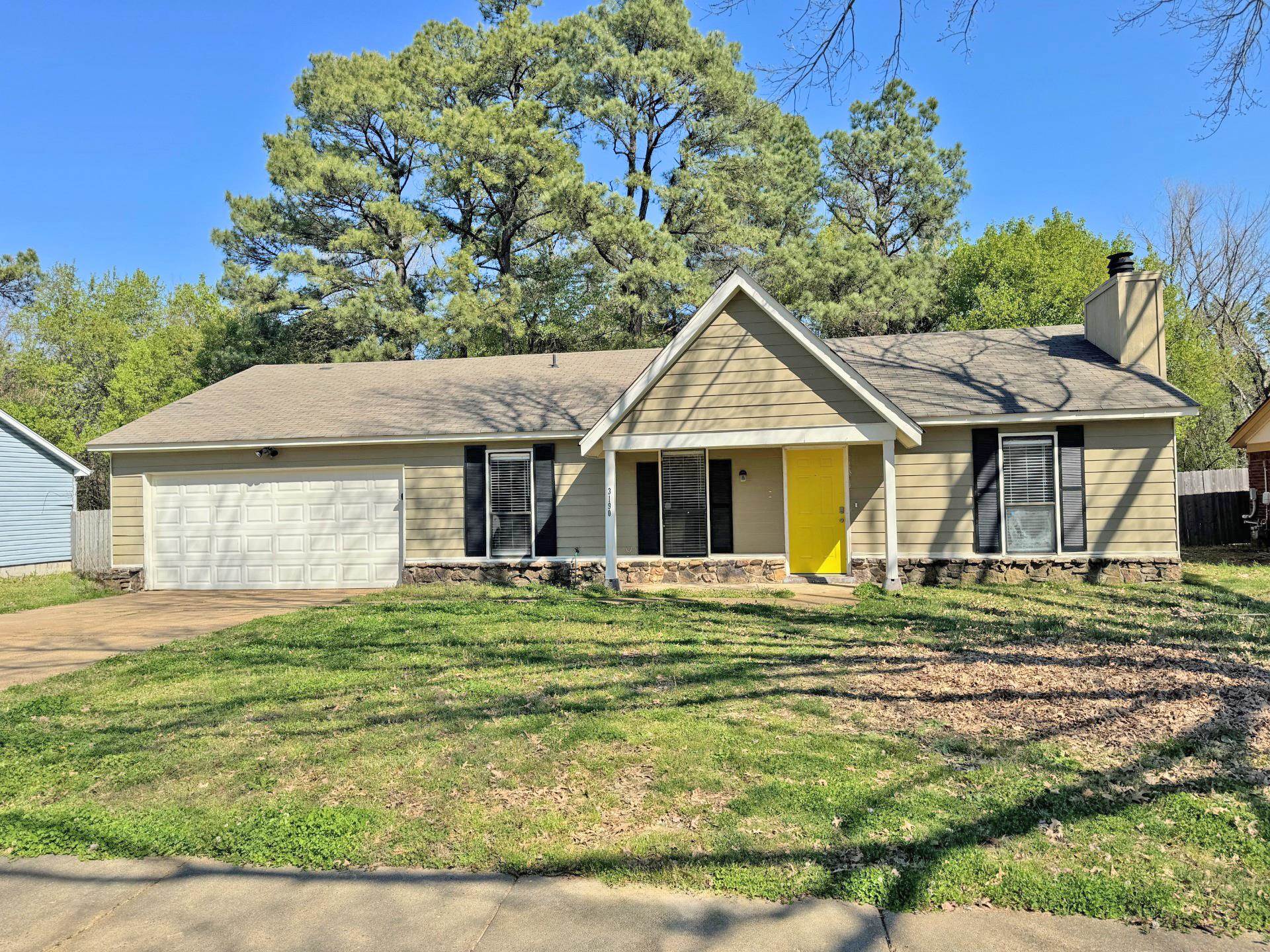 Ranch-style home featuring a garage and a front yard