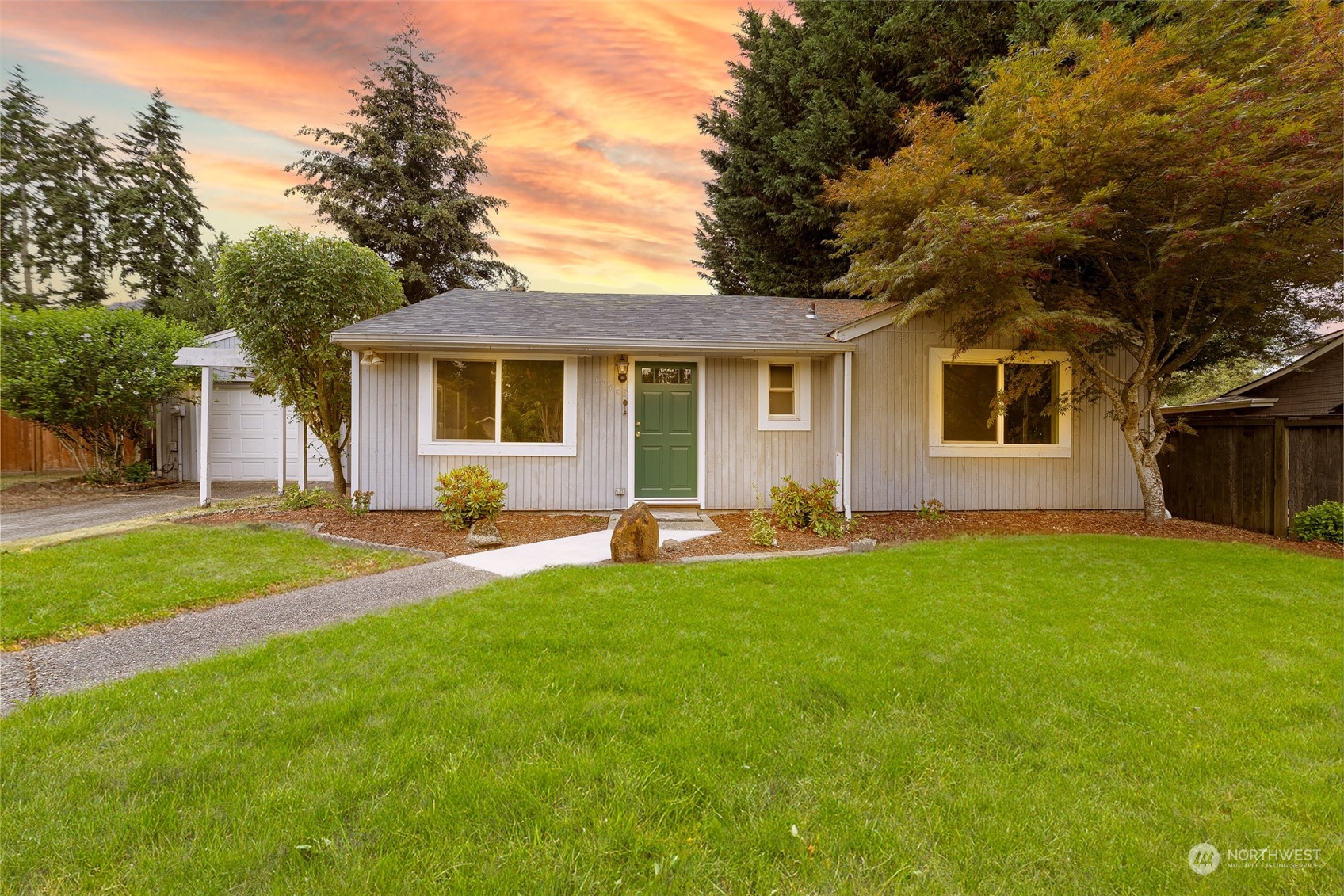 a front view of house with yard and green space