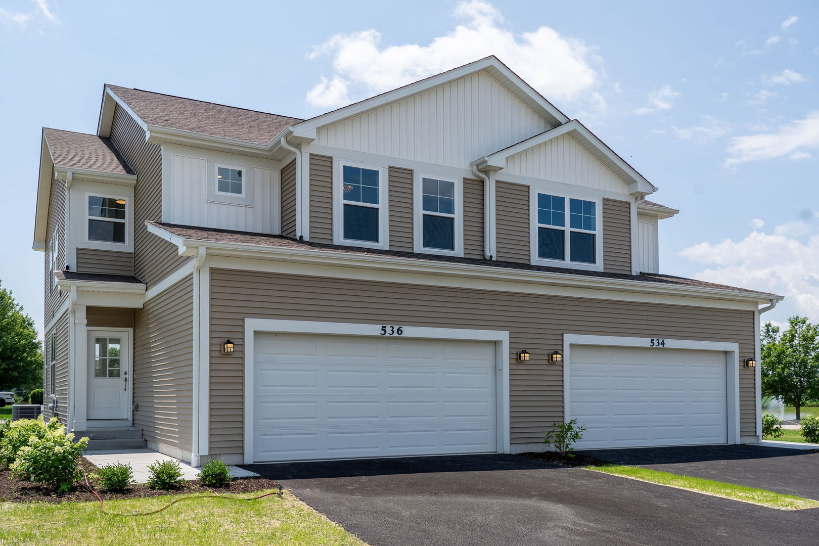 a front view of a house with a yard and garage