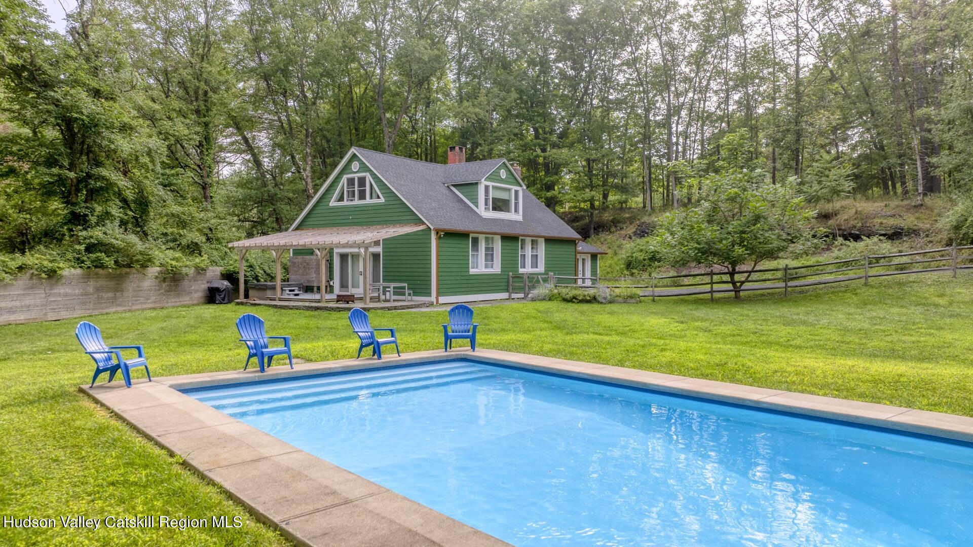 a view of an house with swimming pool and yard