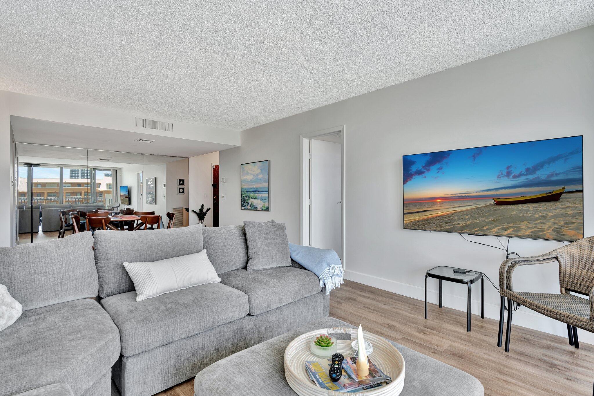 a living room with furniture and wooden floor