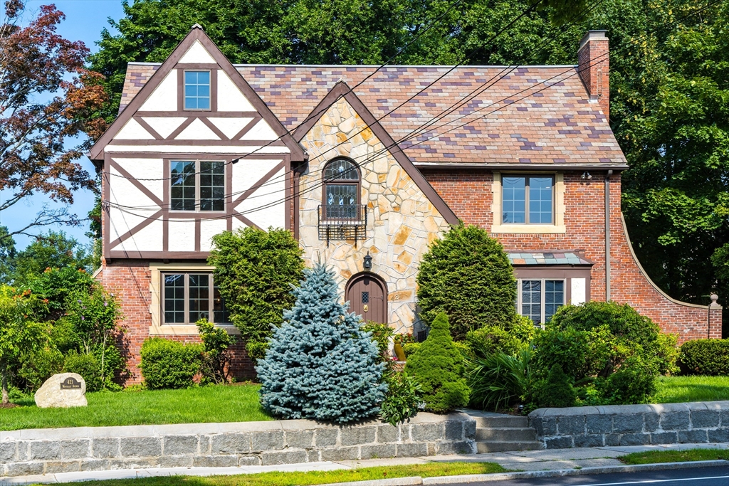 a front view of a house with garden