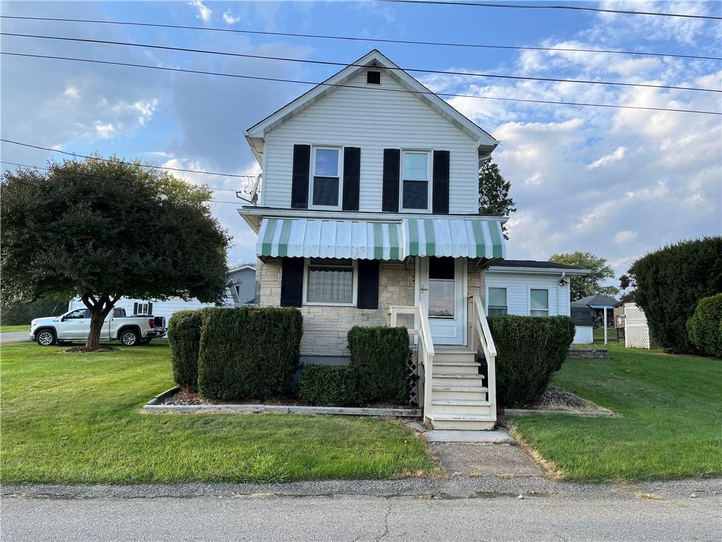 a front view of a house with a yard