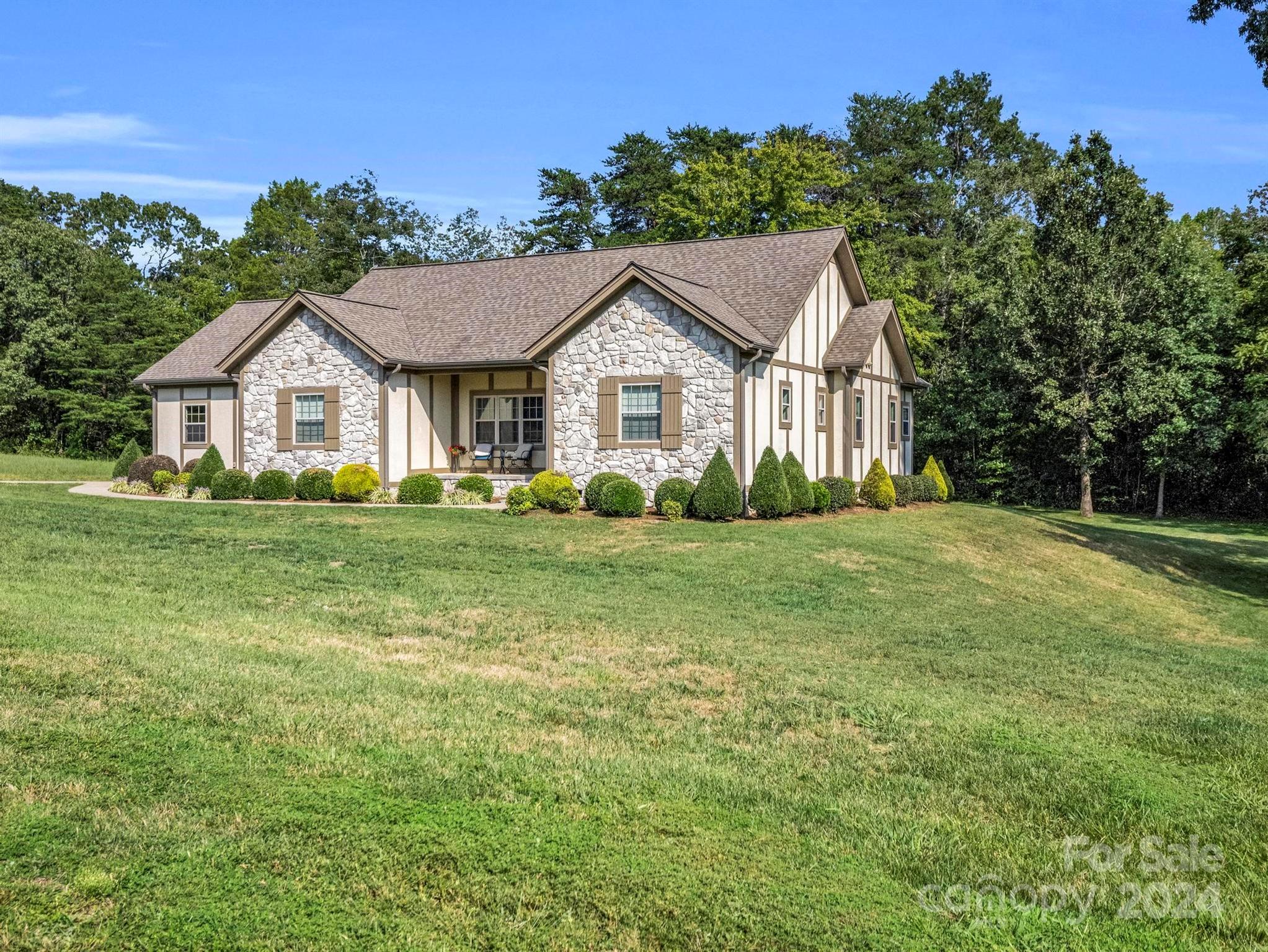 a house with huge green field in front of it