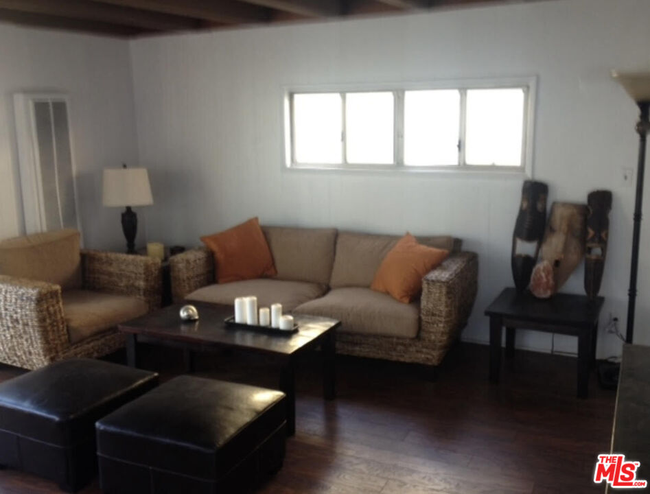 a living room with furniture a rug and a window