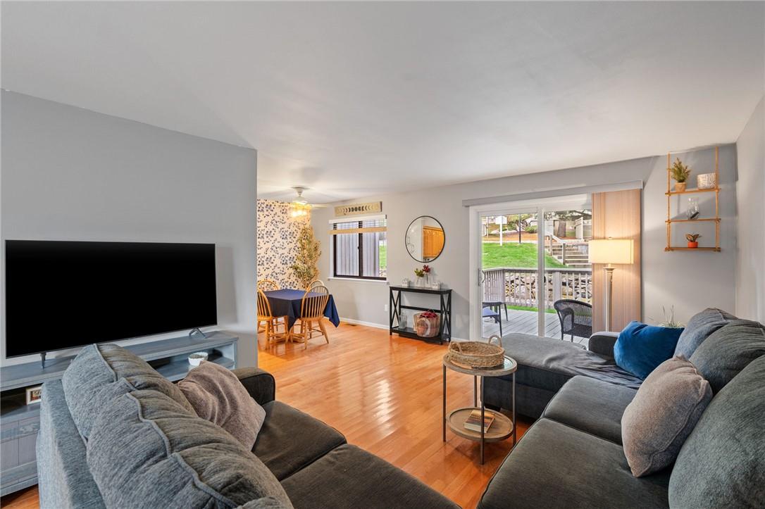 Living room with hardwood floors and ceiling fan