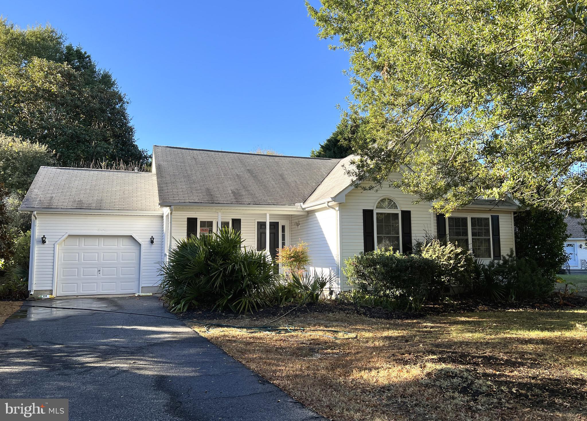 a front view of house with yard and trees