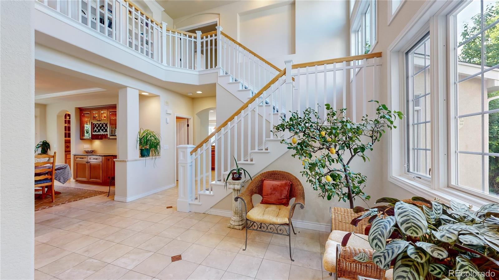 a living room filled with furniture and a potted plant