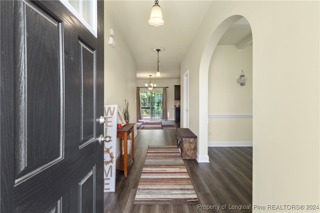 a view of entryway and hall with dining room