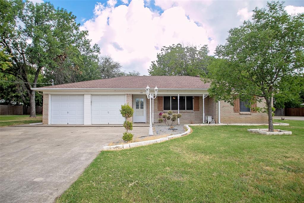 a front view of house with a garden and patio