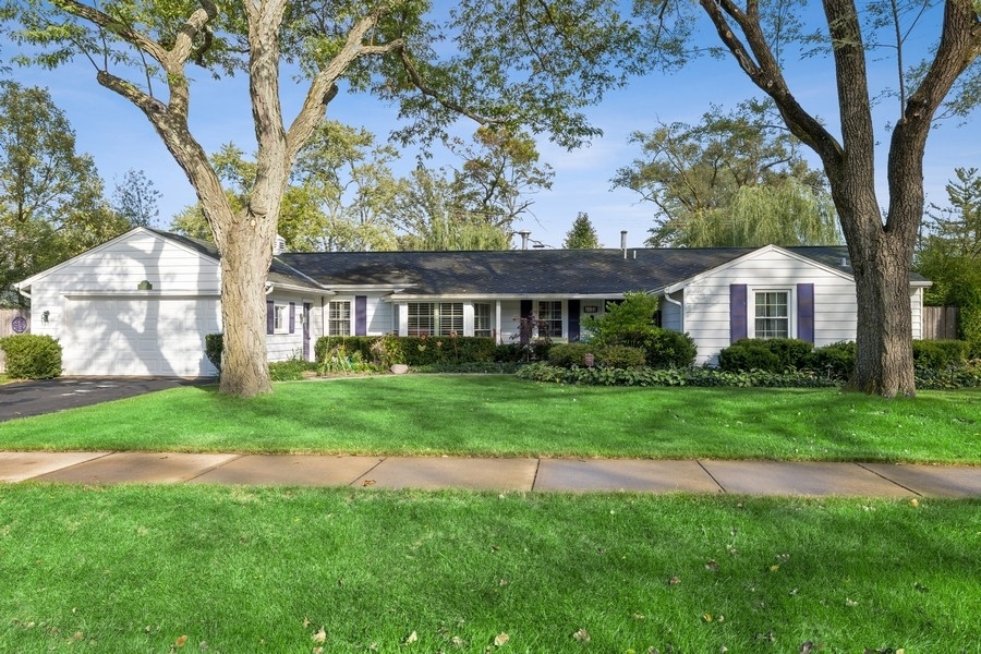 a front view of a house with a yard and garden