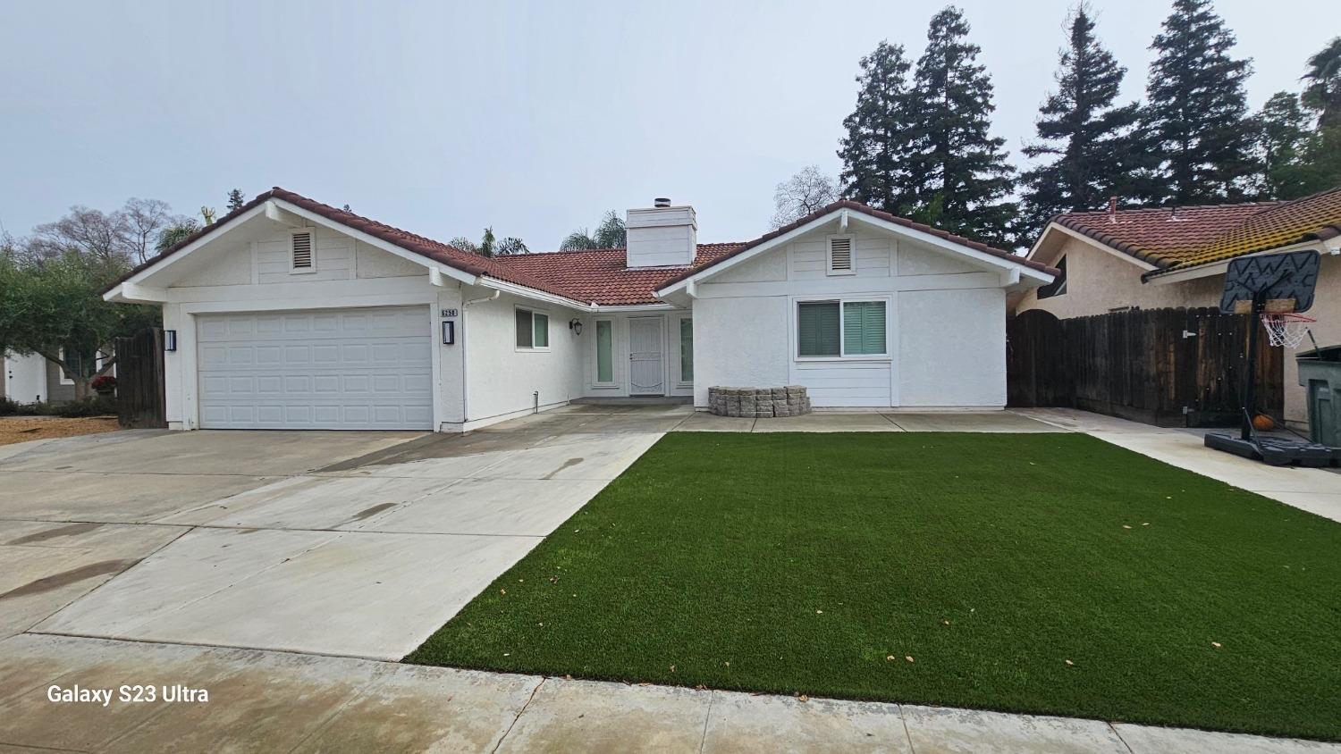 a view of a house with a yard and garage