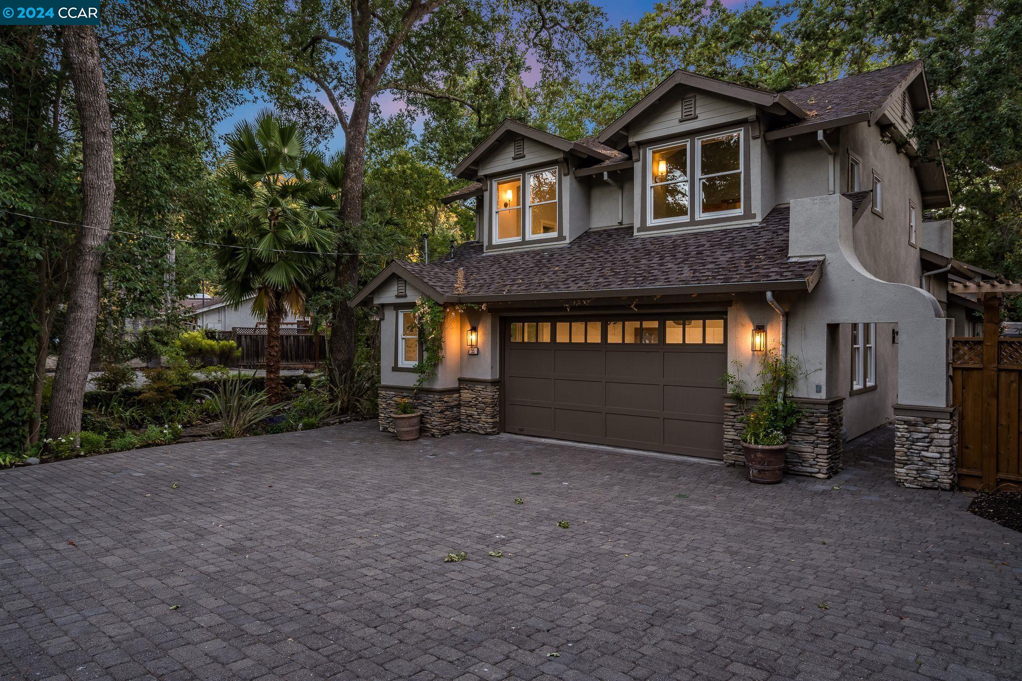 a view of a house with a yard and garage