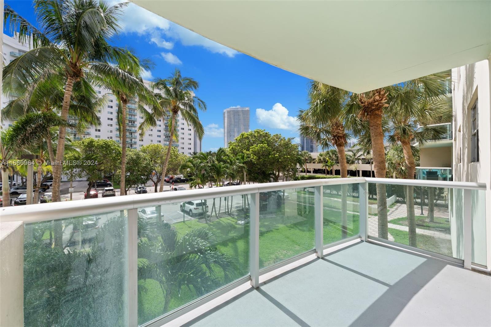 a view of a balcony with yard