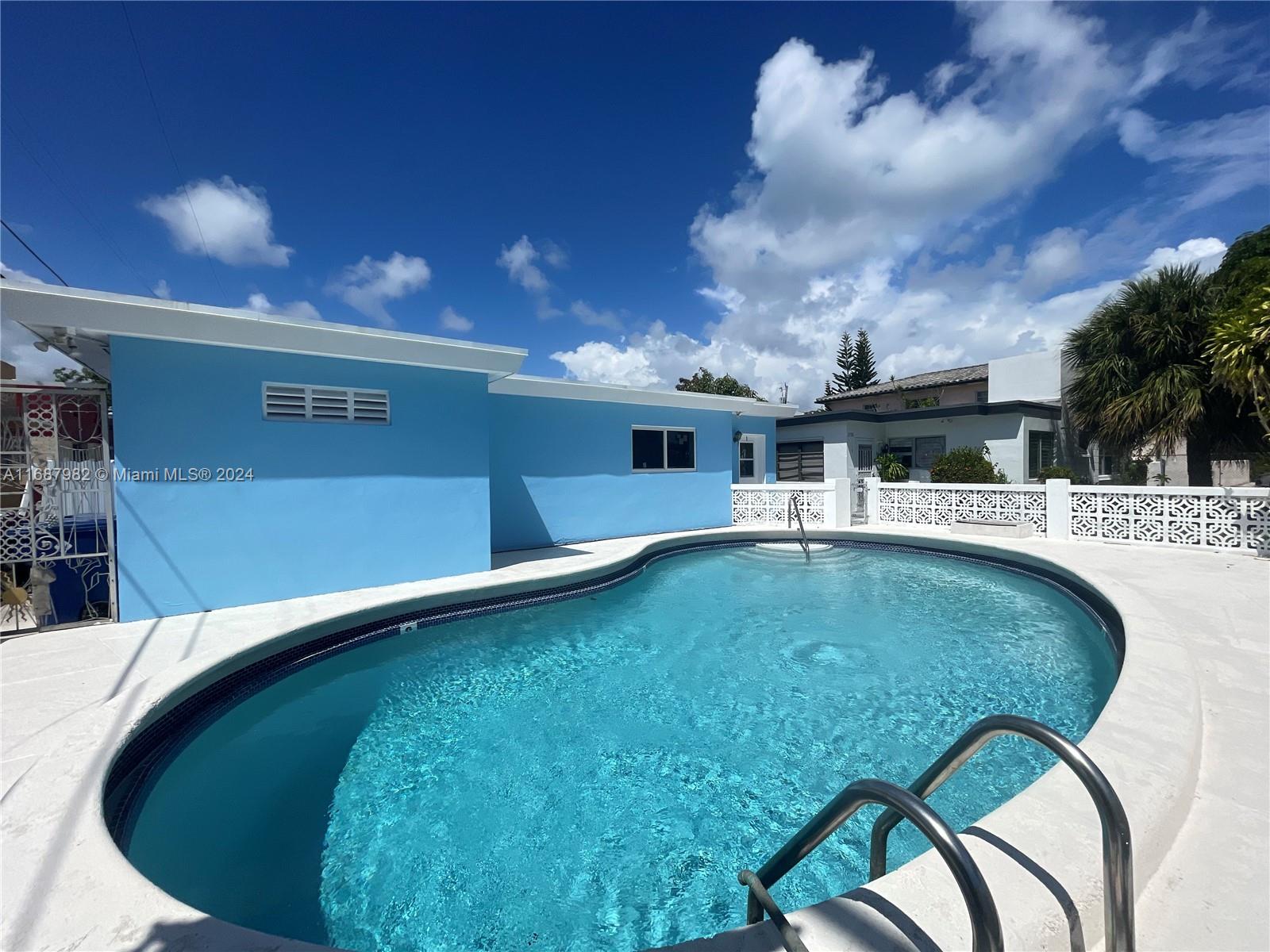 a view of a swimming pool with an outdoor seating