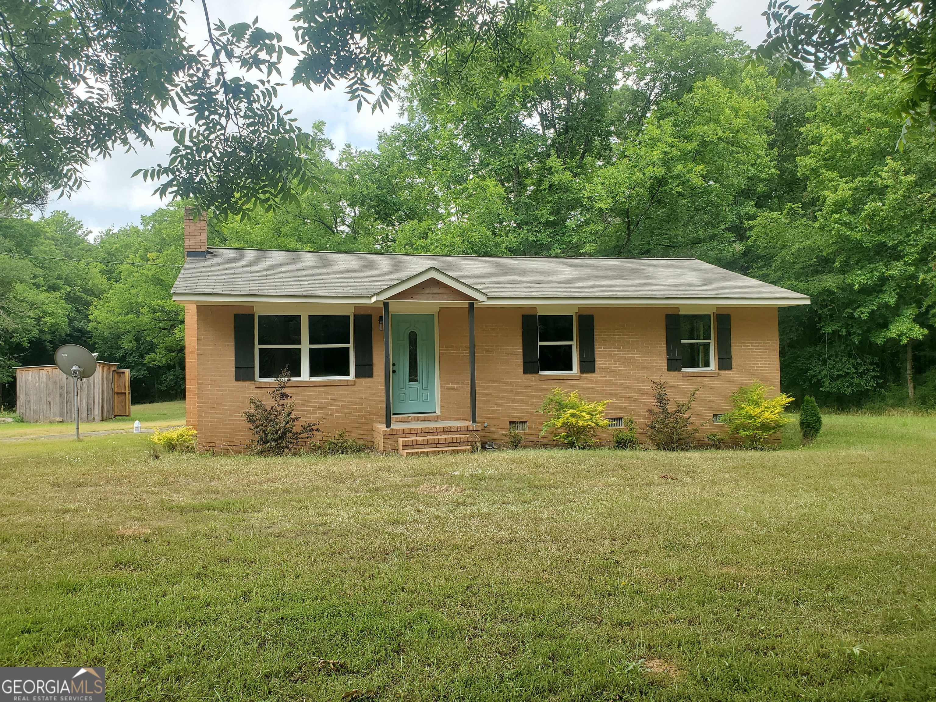 a front view of a house with a garden