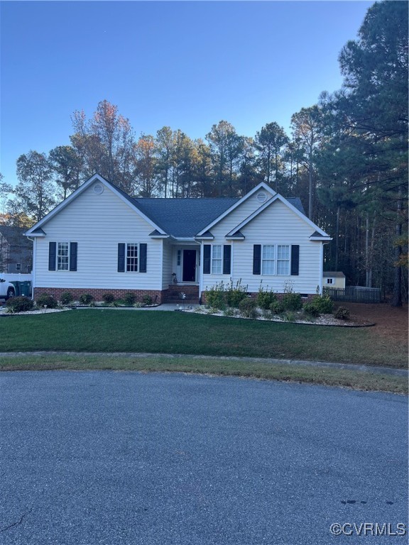 Single story home with a front yard