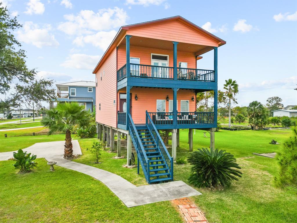 a front view of house with a garden and swimming pool