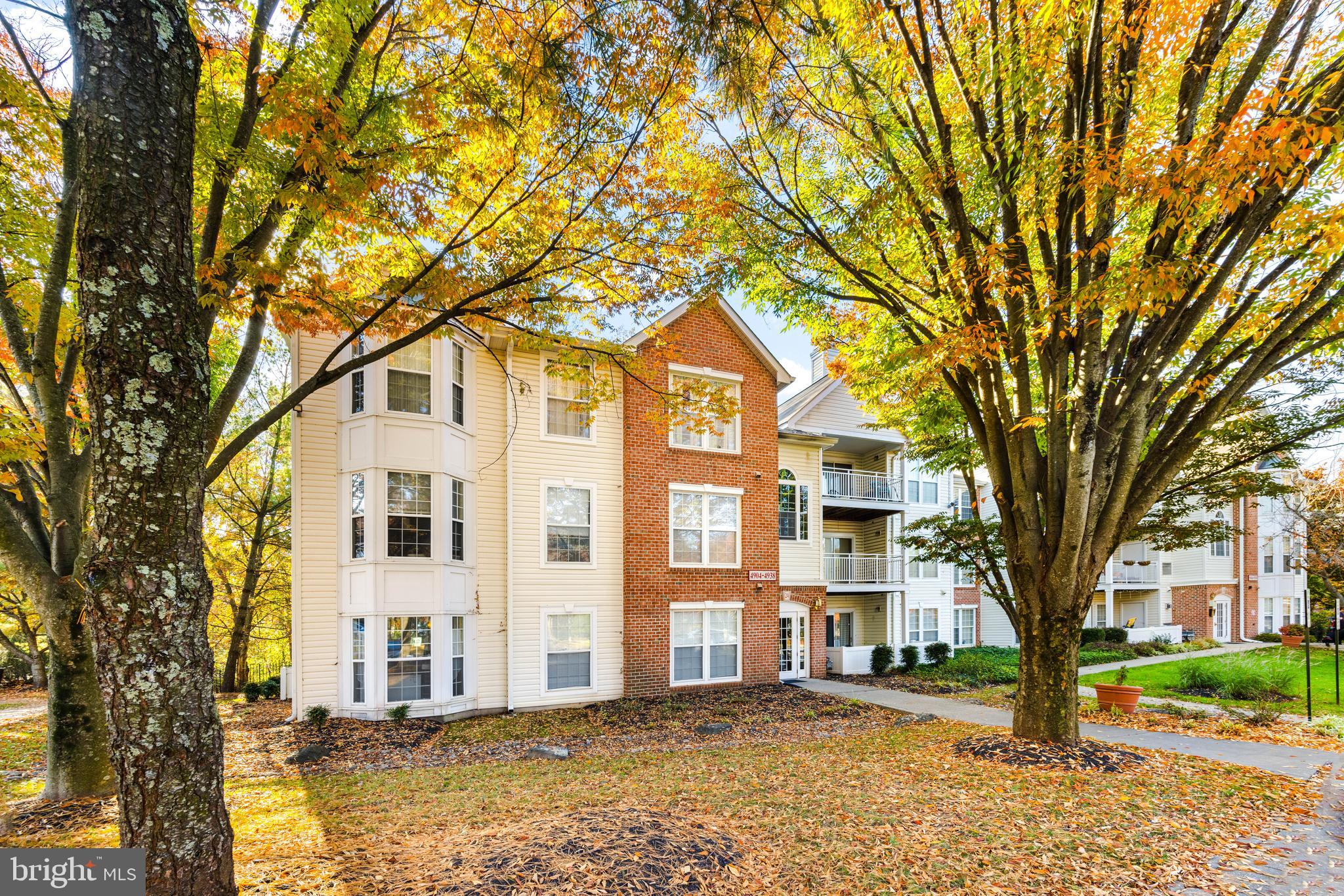 a front view of a residential apartment building with a yard