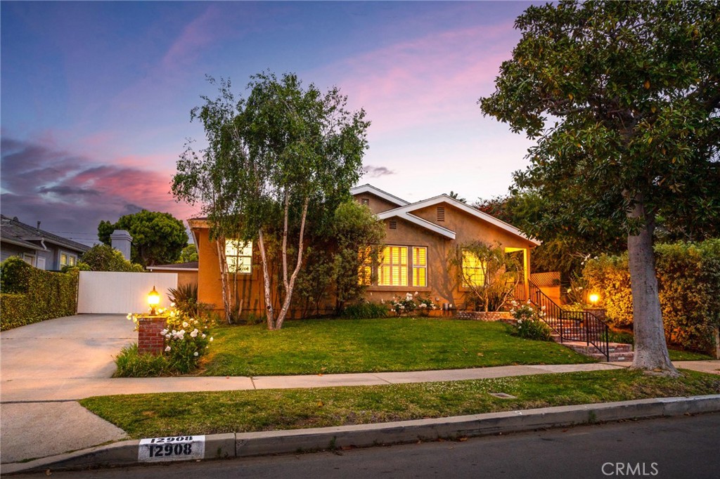 a front view of a house with a yard and a garage