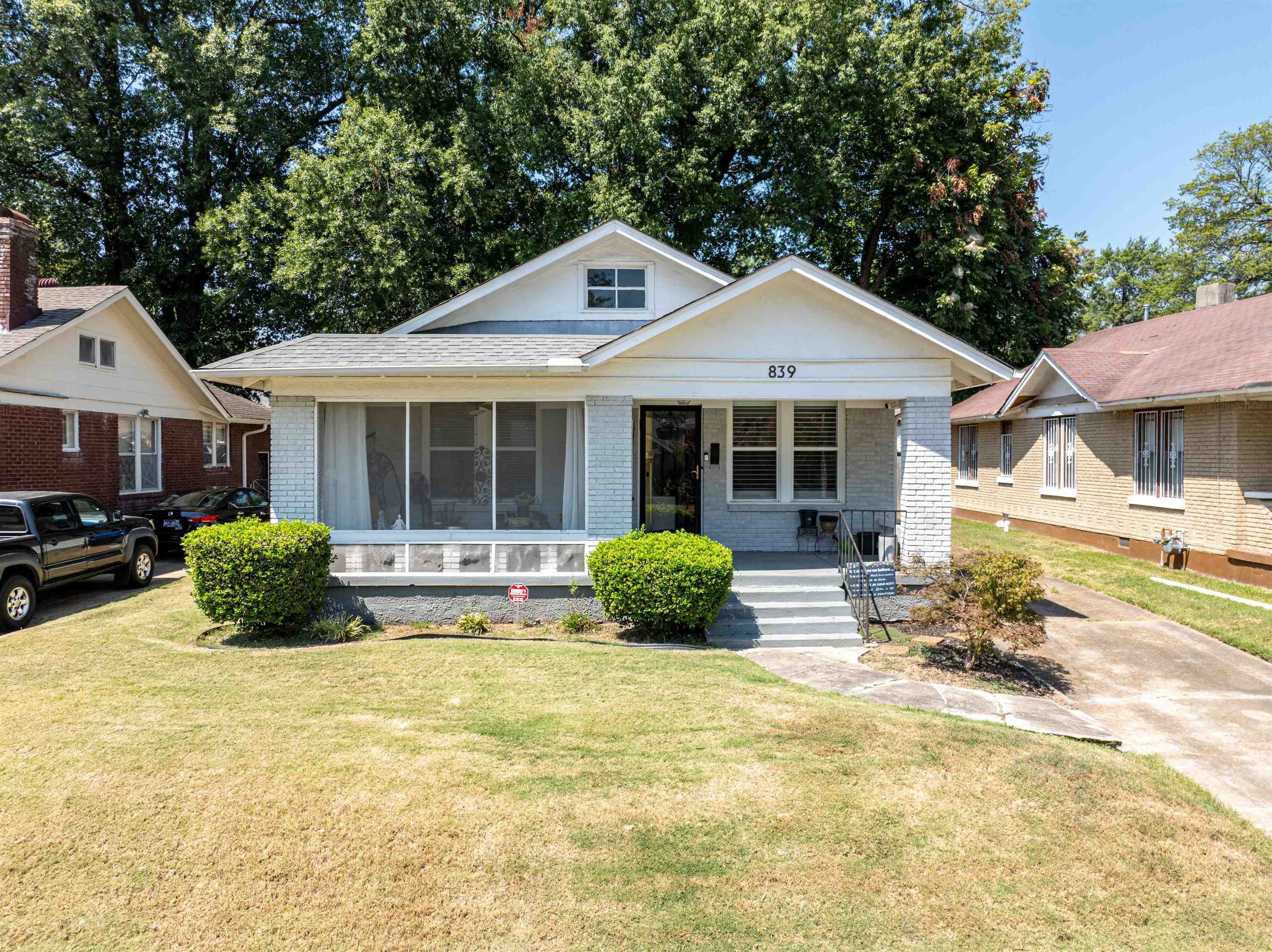 a front view of a house with a yard and outdoor seating