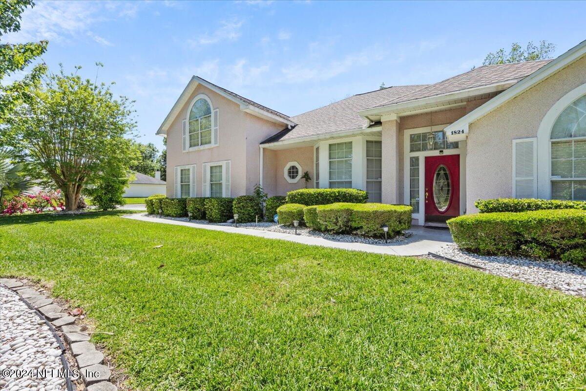 a front view of house with yard and green space