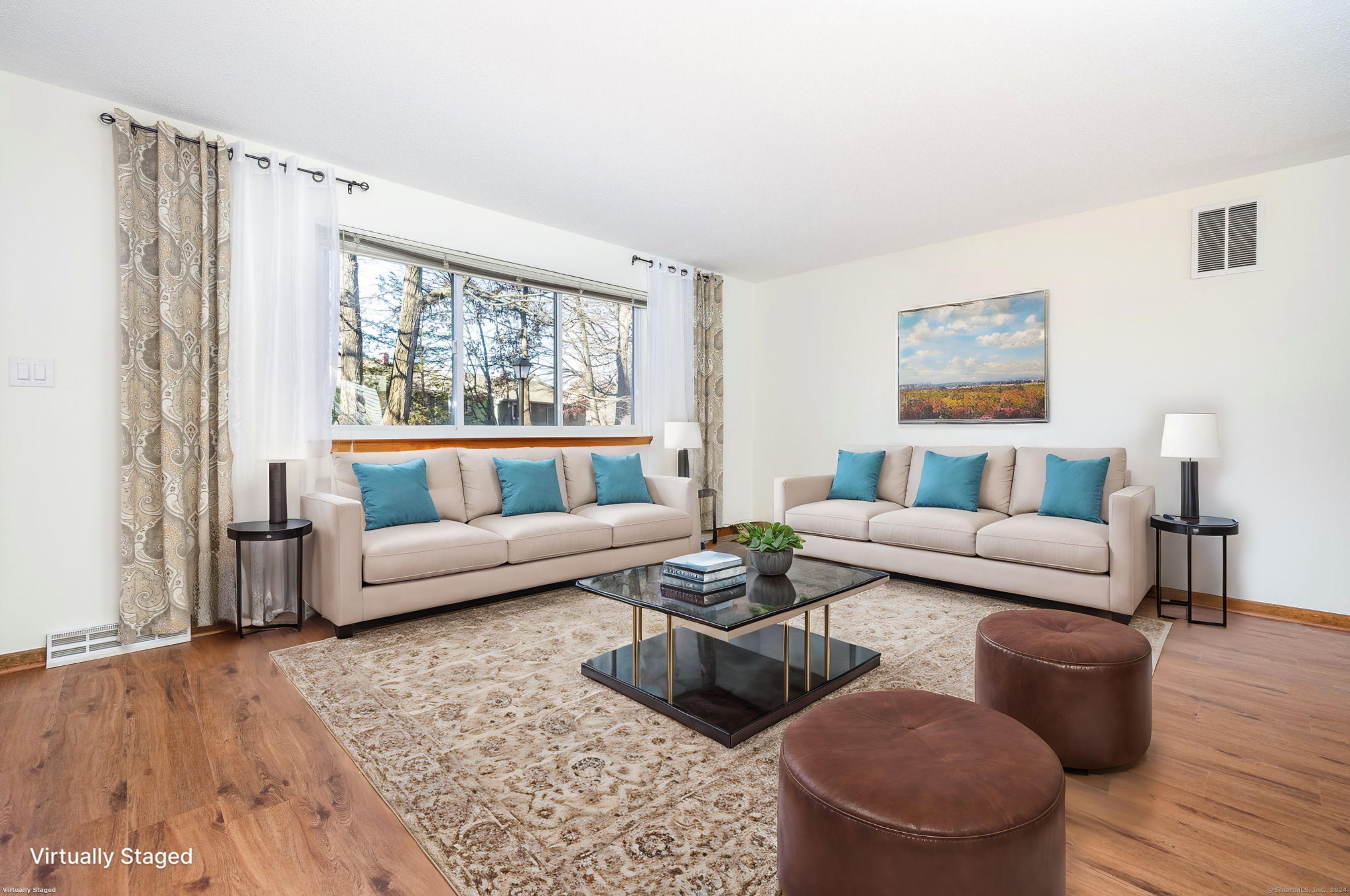 a living room with furniture and a large window