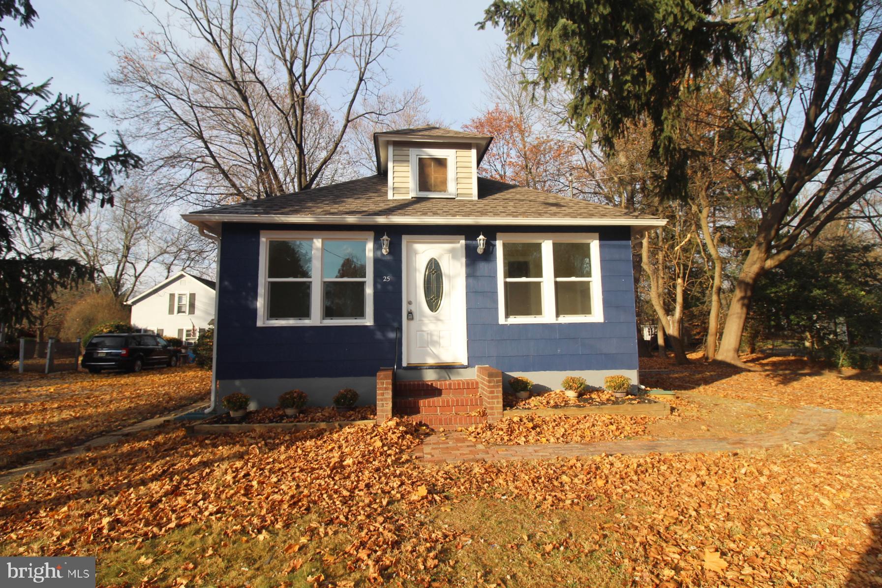 a front view of a house with a yard covered in snow