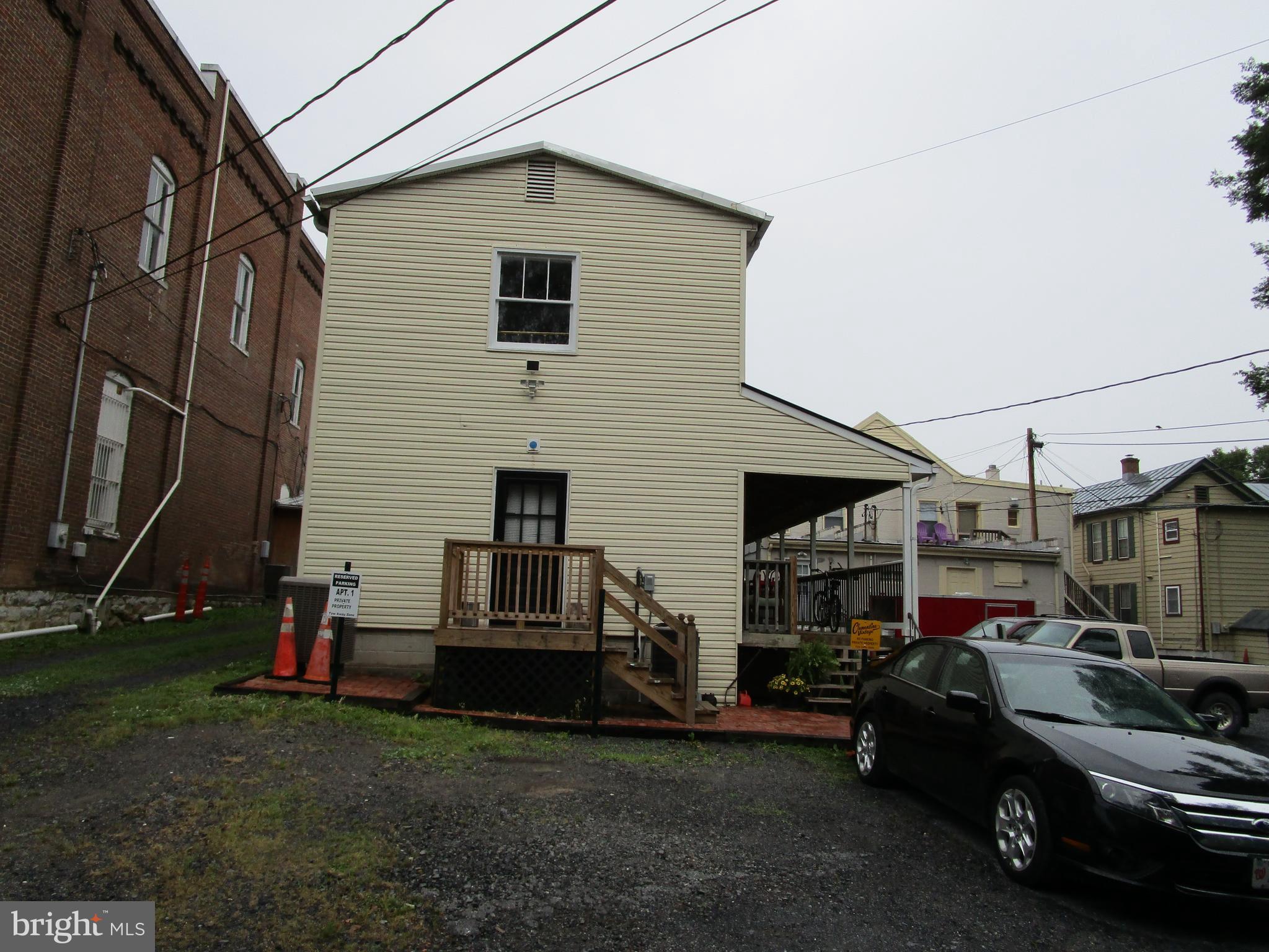 a view of a cars park in front of a house