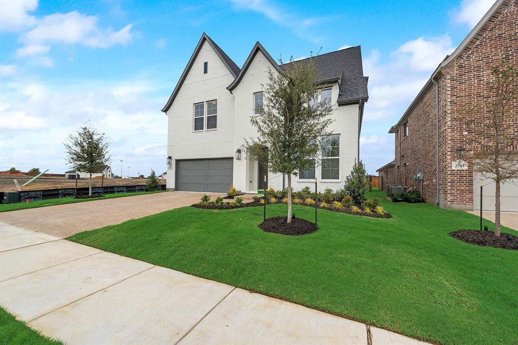 a front view of house with yard and outdoor seating