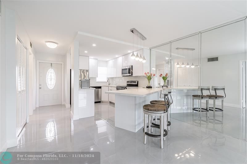 a large kitchen with kitchen island a table and chairs