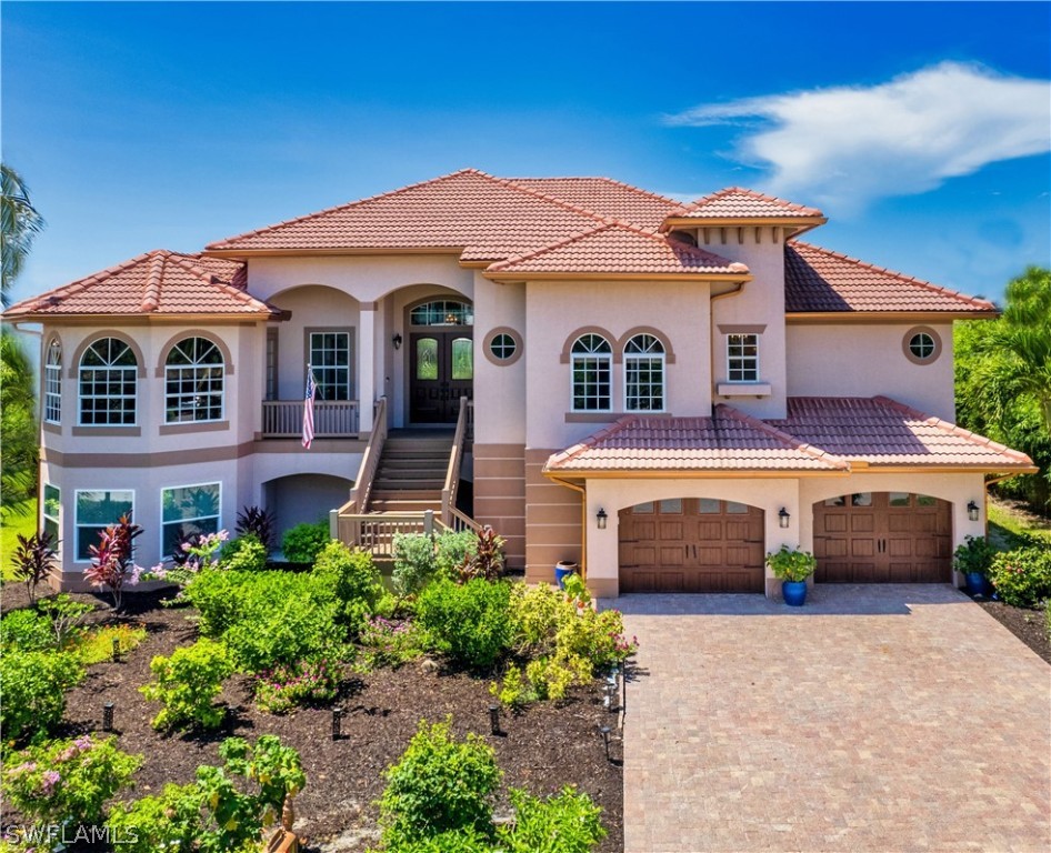 a front view of a house with a yard and garage