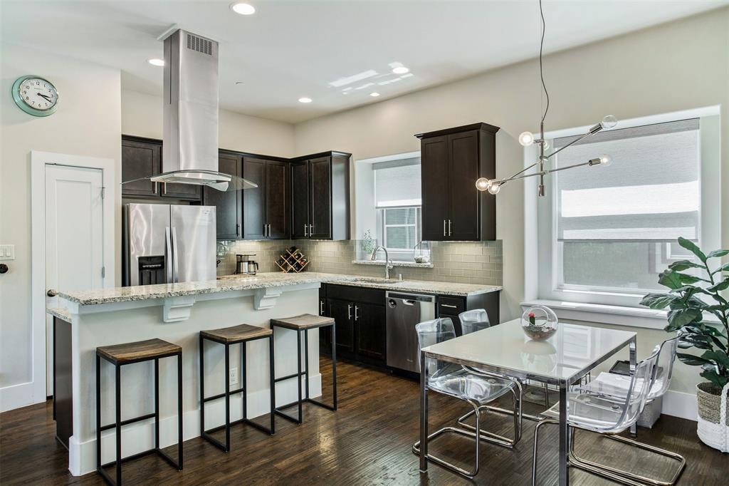 a kitchen with stainless steel appliances granite countertop a stove refrigerator and cabinets