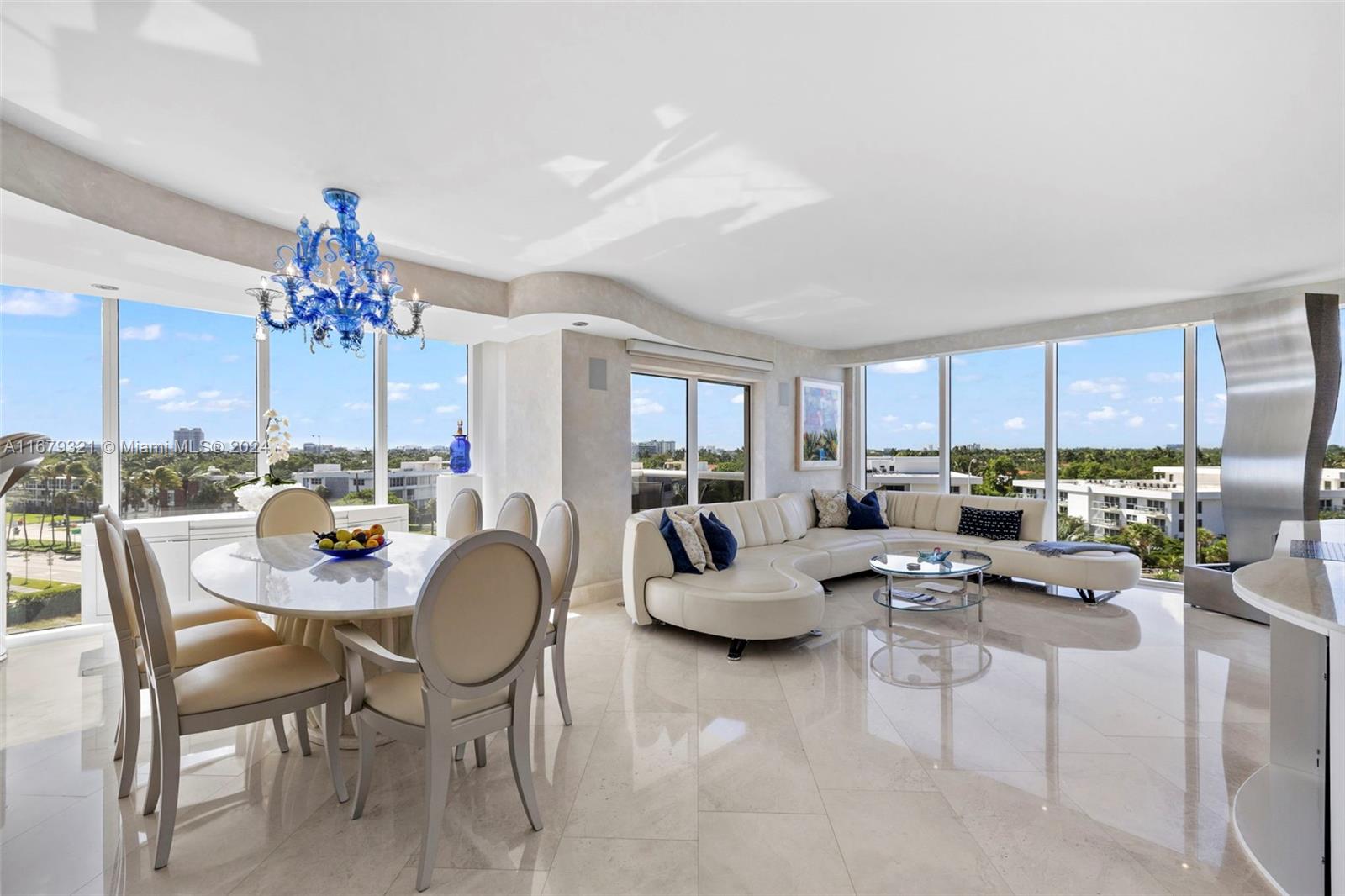 a dining room with furniture chandelier and a rug