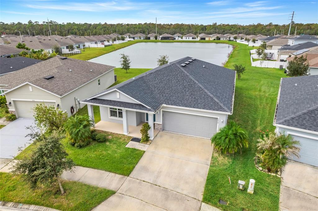 an aerial view of a house with a yard