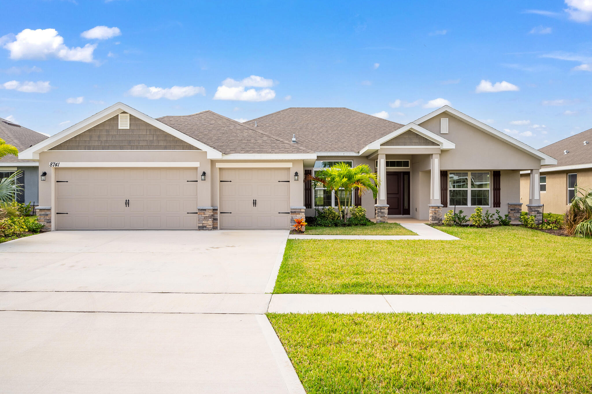 a view of a house with a backyard and a garage