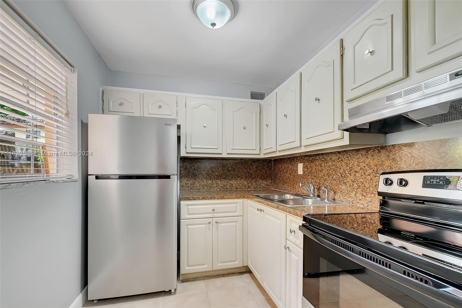 a white refrigerator freezer sitting inside of a kitchen