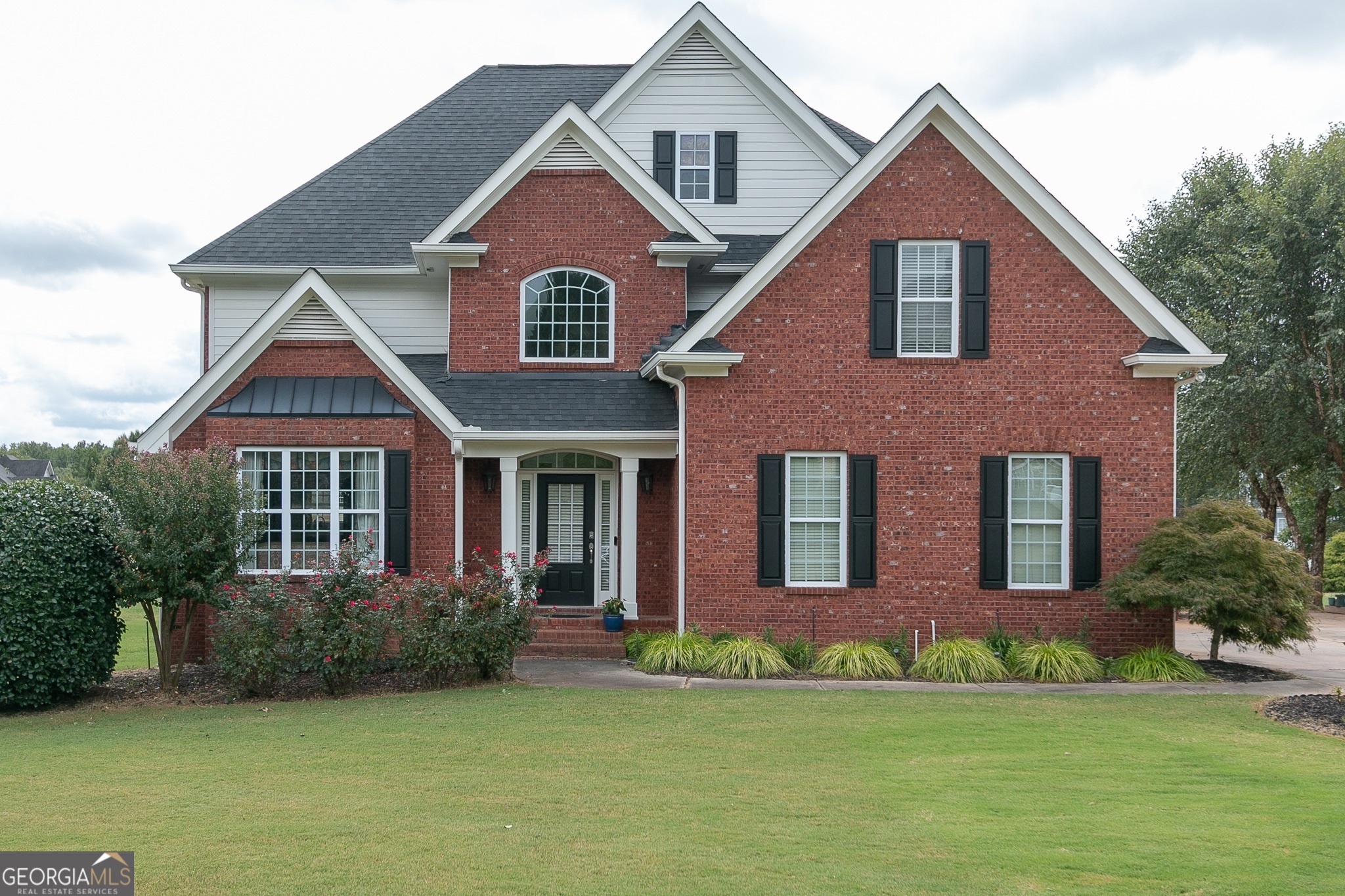 a front view of a house with a yard