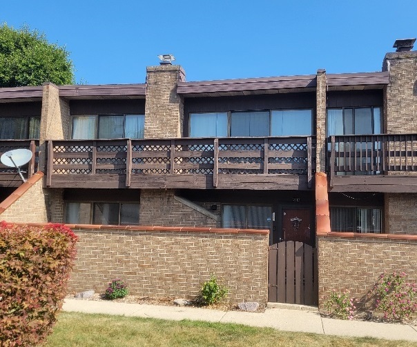 a view of a brick house with large windows