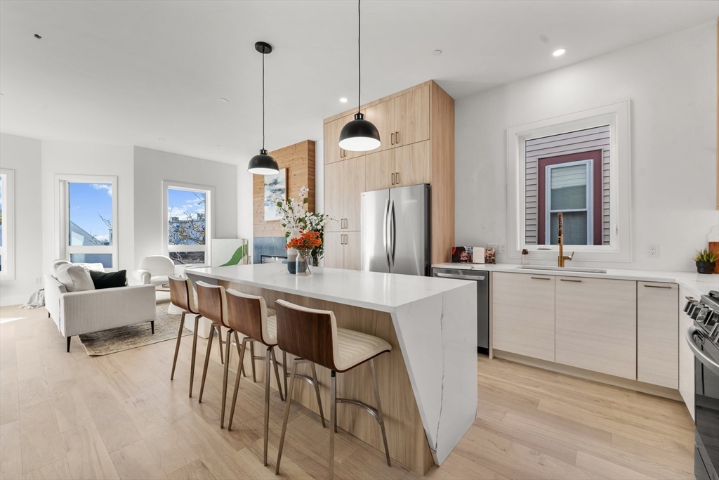 a kitchen with sink cabinets and dining table